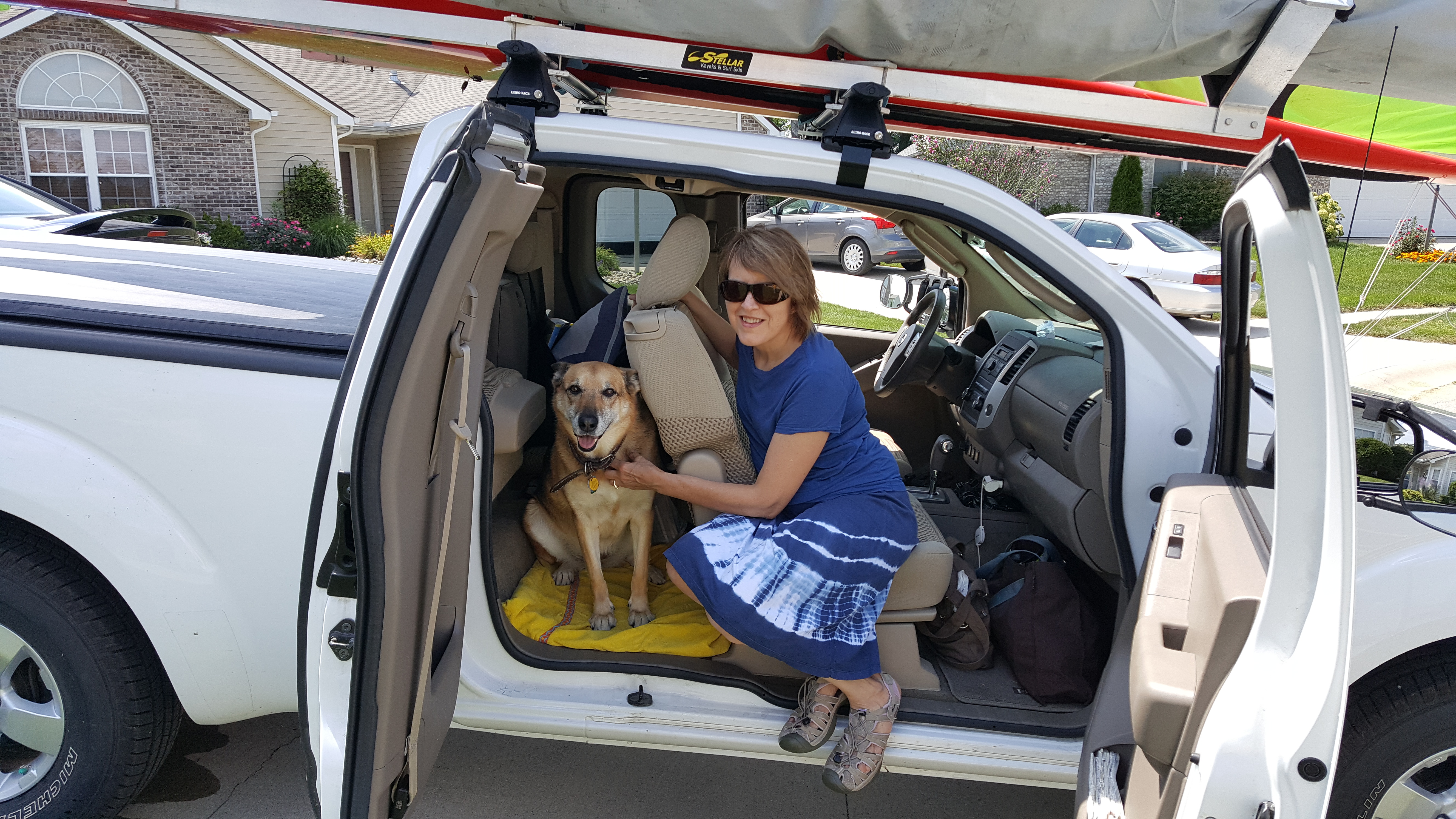 woman with dog, German shepherd, travelling, pet, Nissan Frontier, trip, jump seat