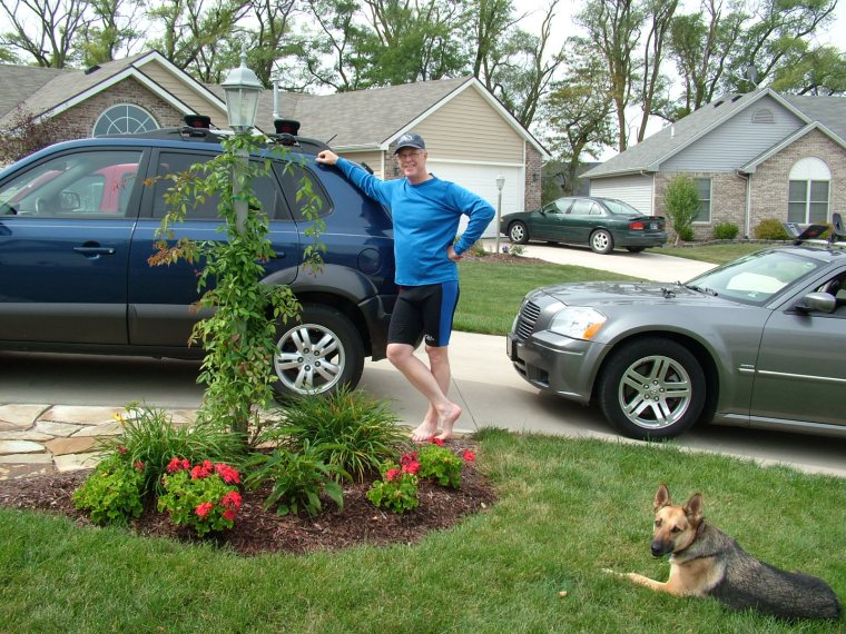 Hyundai, Tuscon, German shepherd, garden, light pole, garden bed, Dodge Magnum, paddling gear, front driveway, holding things lightly, Christian man